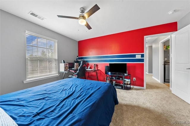 carpeted bedroom featuring visible vents and ceiling fan