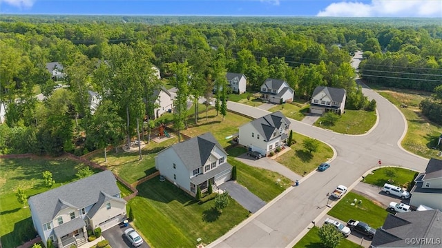 birds eye view of property featuring a residential view and a wooded view