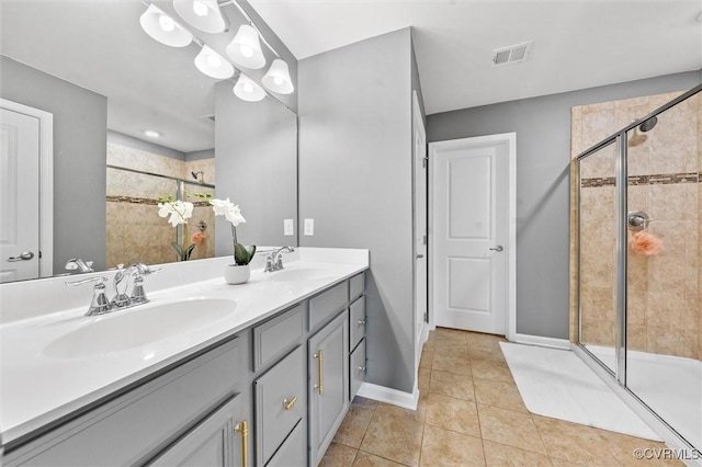 full bathroom with visible vents, a sink, tile patterned flooring, and a shower stall