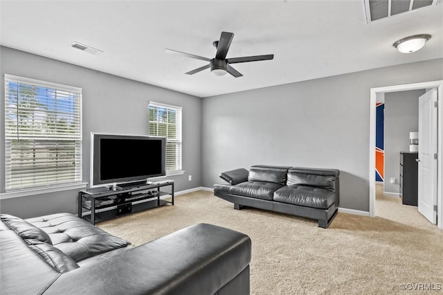 living room with visible vents, carpet flooring, baseboards, and a ceiling fan
