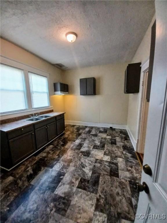 130 Elm St, Petersburg, VA 23803 - kitchen with a textured ceiling, a sink, and baseboards