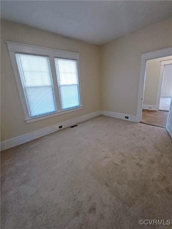 130 Elm St, Petersburg, VA 23803 - spare room with plenty of natural light, carpet floors, and baseboards