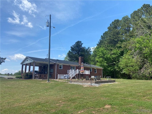 1195 Stingy Lane Rd, Blackstone, VA 23824 - rear view of house with a lawn, a patio area, a chimney, and a deck
