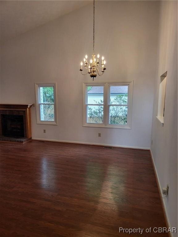 80 Anchorage Dr, Newport News, VA 23602 - unfurnished dining area with an inviting chandelier, baseboards, dark wood finished floors, and high vaulted ceiling