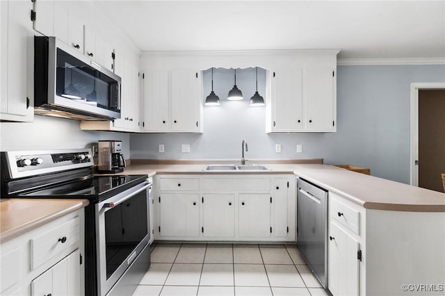 kitchen with appliances with stainless steel finishes, a sink, light countertops, a peninsula, and ornamental molding