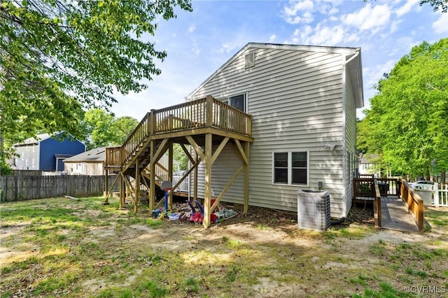 rear view of house with fence, central AC unit, a deck, and stairway