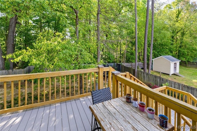 deck featuring an outbuilding, a fenced backyard, and a storage unit