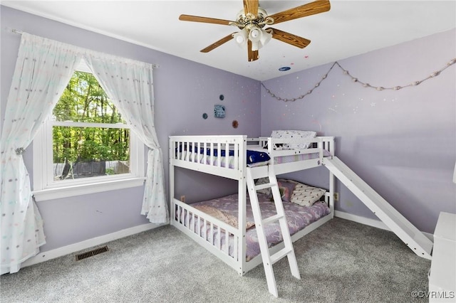 bedroom featuring carpet floors, baseboards, visible vents, and ceiling fan