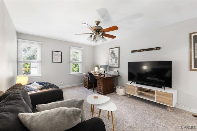 living area featuring baseboards, carpet, a ceiling fan, and visible vents