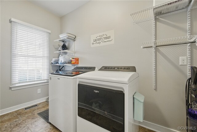 washroom featuring baseboards, laundry area, washing machine and dryer, and visible vents