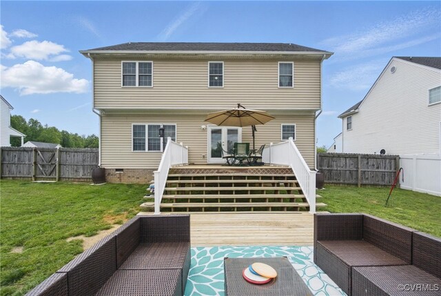 rear view of house with a lawn, a deck, an outdoor hangout area, and a fenced backyard