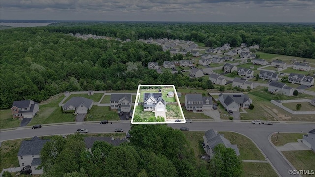 aerial view featuring a view of trees and a residential view