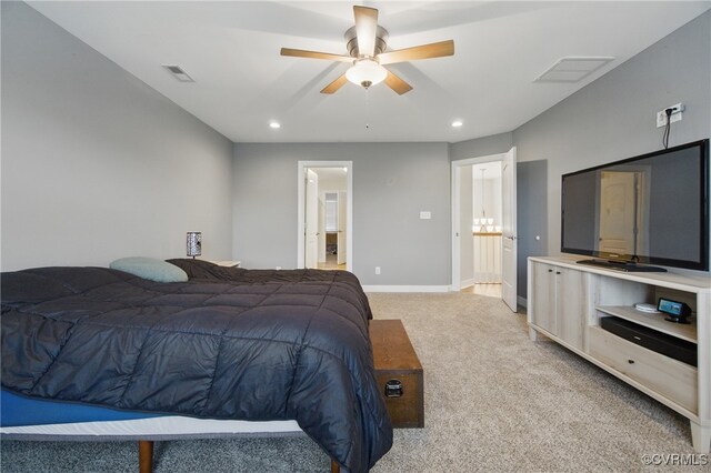 bedroom featuring light colored carpet, baseboards, ensuite bathroom, and visible vents