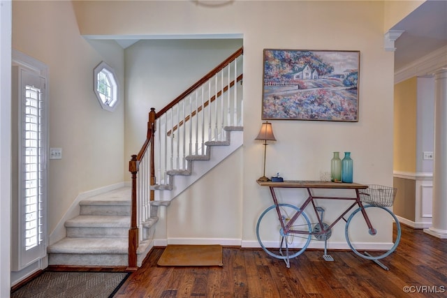 entryway with baseboards, wood finished floors, and stairway