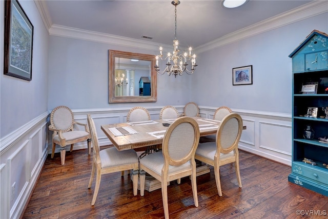 dining room featuring ornamental molding, wainscoting, dark wood finished floors, and a notable chandelier