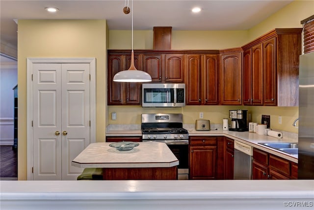 kitchen with light countertops, stainless steel appliances, hanging light fixtures, and recessed lighting