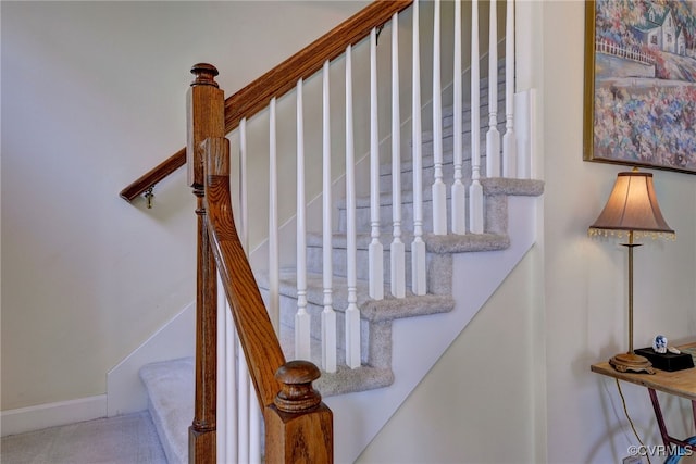 staircase featuring baseboards