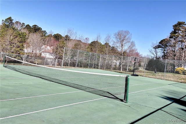 view of tennis court featuring fence