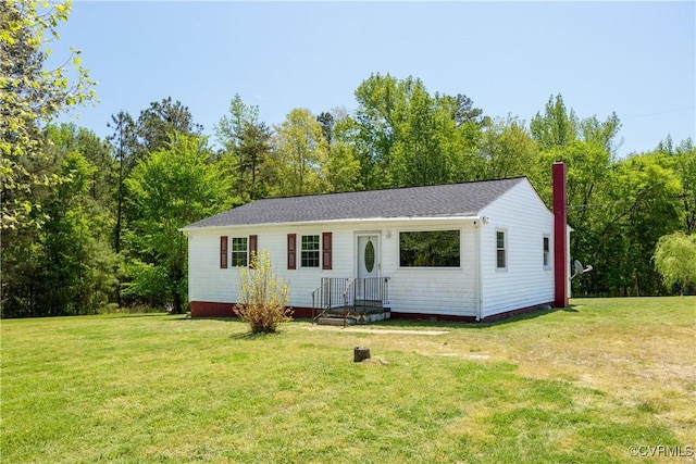 view of front of house with a front lawn and a chimney