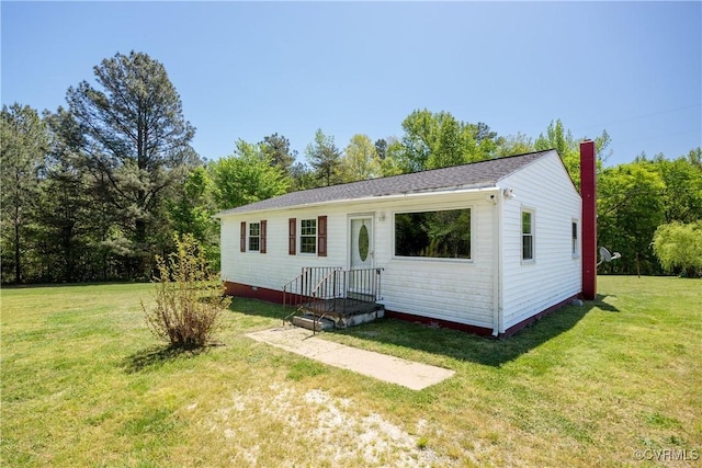 view of front of house with a chimney and a front yard