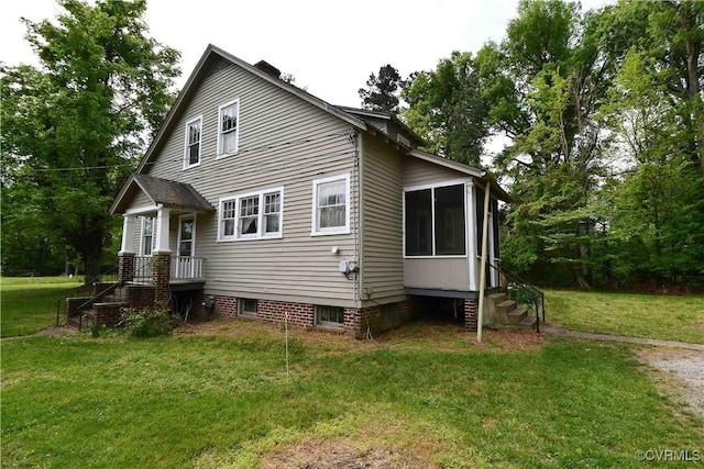 exterior space with a yard and a sunroom