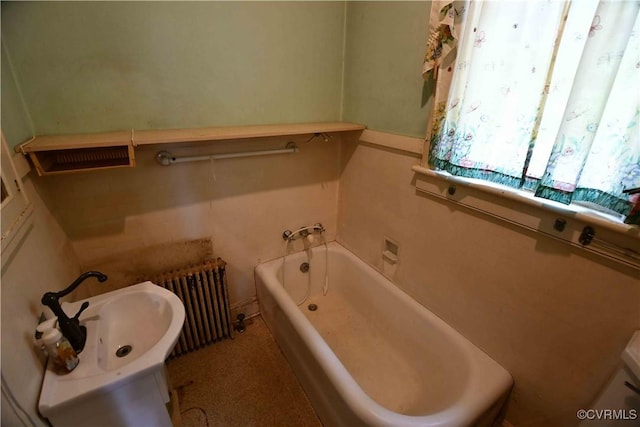 full bath featuring radiator heating unit and a bathtub