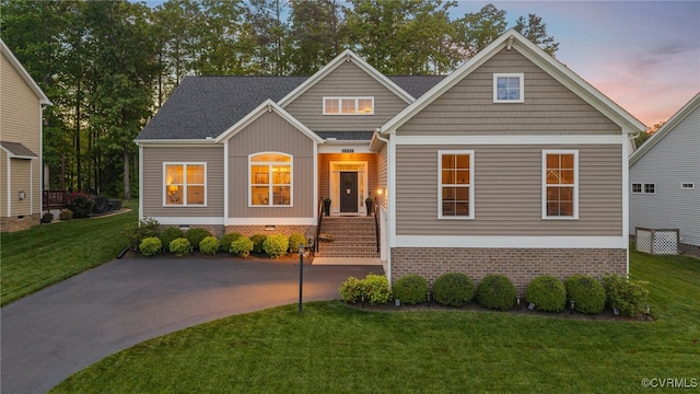 craftsman-style house with a yard and crawl space