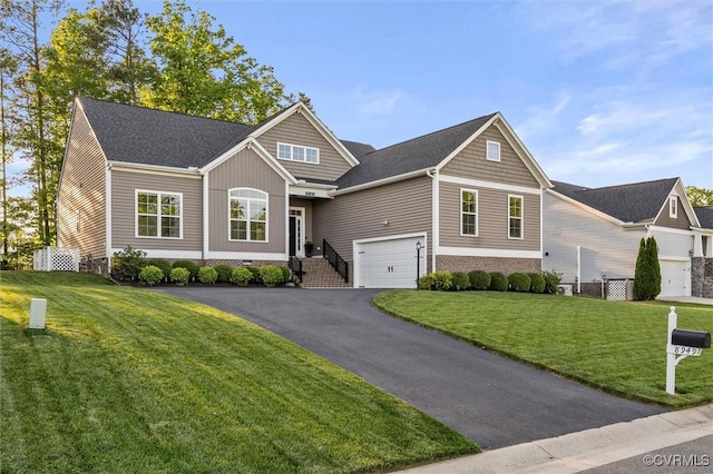 craftsman inspired home with driveway and a front yard