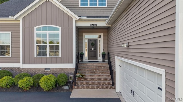 property entrance featuring a garage and crawl space