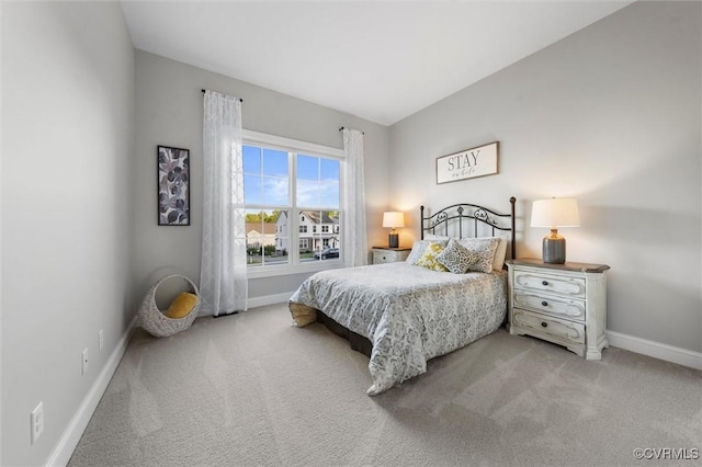 carpeted bedroom featuring baseboards