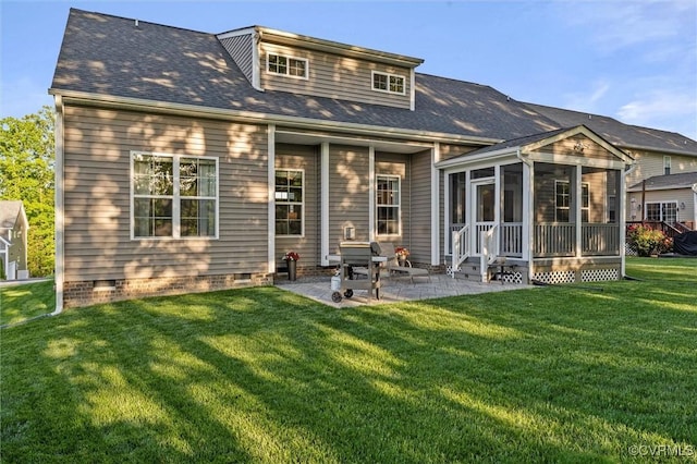 rear view of property featuring a sunroom, a yard, a patio area, crawl space, and roof with shingles