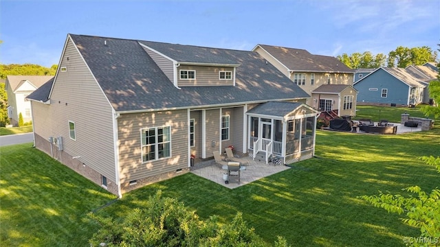 rear view of house with a sunroom, a patio, a yard, crawl space, and a residential view