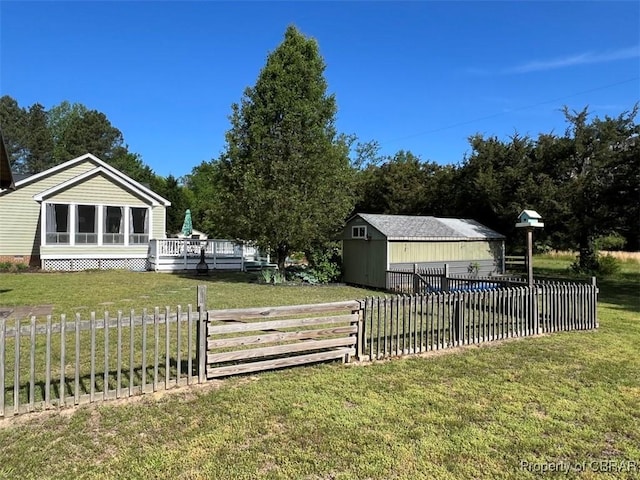 497 Mill Wharf Rd, Wake, VA 23176 - view of yard featuring a deck, an outdoor structure, fence, a storage unit, and a swimming pool