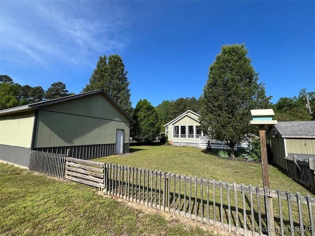 view of yard featuring fence and an outbuilding