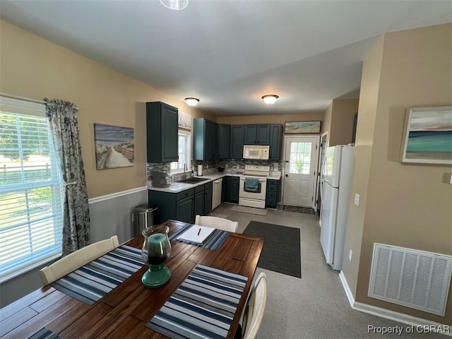 497 Mill Wharf Rd, Wake, VA 23176 - kitchen featuring a sink, visible vents, baseboards, white appliances, and light countertops