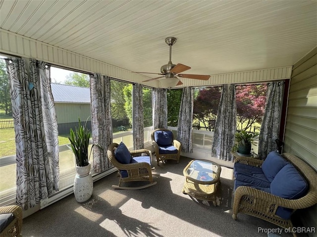 sunroom / solarium featuring ceiling fan