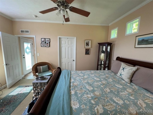 carpeted bedroom featuring a ceiling fan, baseboards, visible vents, and ornamental molding