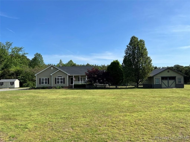ranch-style house with a storage unit, an outdoor structure, and a front lawn