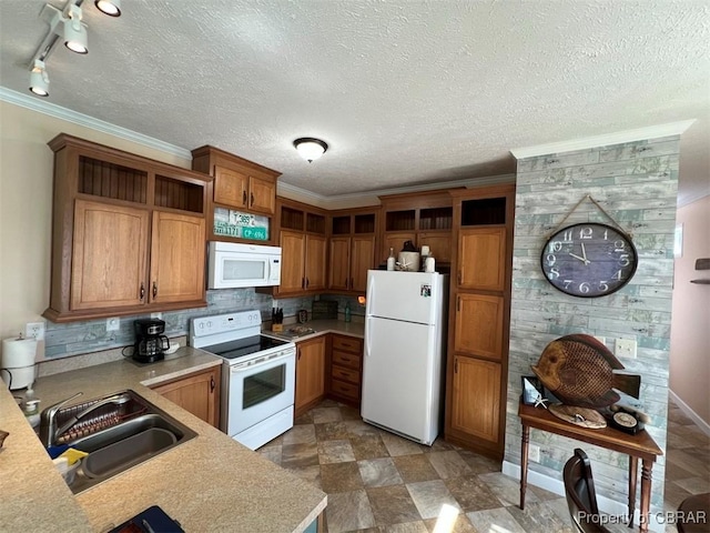 kitchen with open shelves, ornamental molding, white appliances, light countertops, and a sink