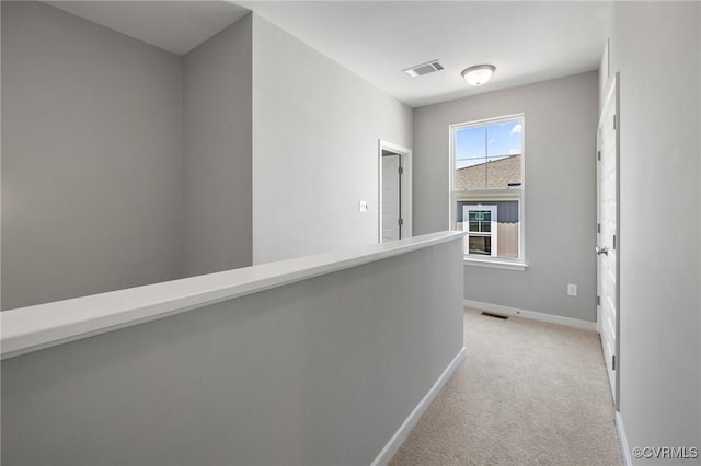hall featuring baseboards, light carpet, an upstairs landing, and visible vents