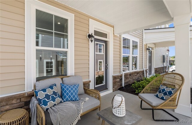 view of patio featuring covered porch and outdoor lounge area