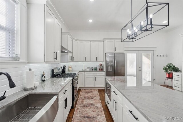 1910 Rose Ave, Richmond, VA 23222 - kitchen with backsplash, a sink, ventilation hood, stainless steel appliances, and white cabinetry
