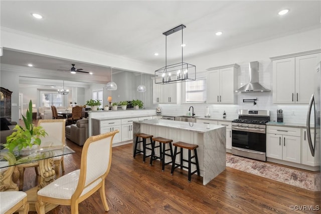 1910 Rose Ave, Richmond, VA 23222 - kitchen featuring crown molding, a sink, wall chimney exhaust hood, stainless steel range with gas cooktop, and decorative backsplash