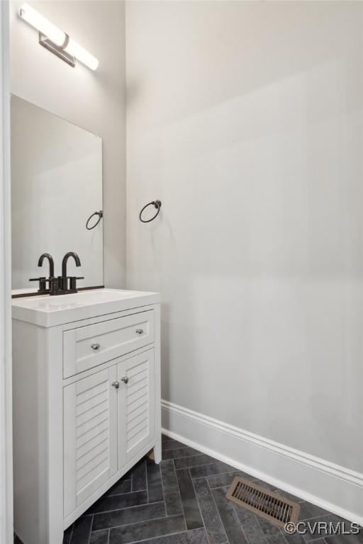 1910 Rose Ave, Richmond, VA 23222 - bathroom featuring baseboards, visible vents, and vanity
