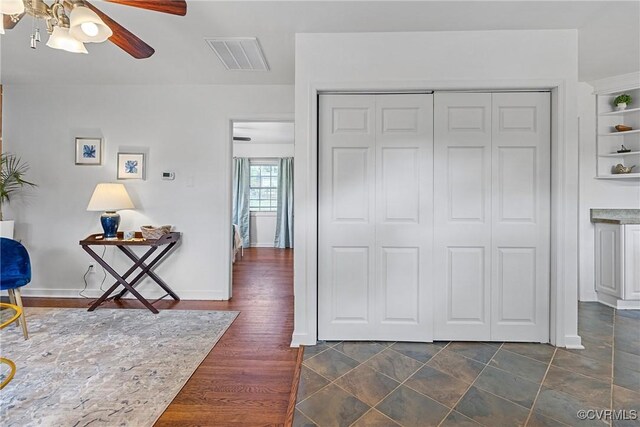 interior space featuring visible vents, a ceiling fan, and a closet