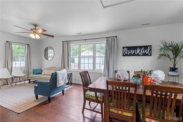 dining area featuring baseboards, ceiling fan, wood finished floors, and visible vents