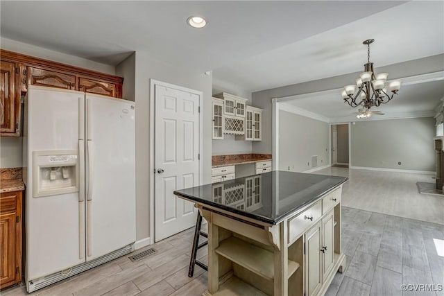 kitchen with an inviting chandelier, open shelves, ornamental molding, light wood finished floors, and white fridge with ice dispenser