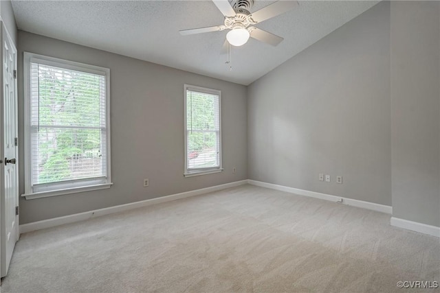 carpeted empty room with baseboards, a textured ceiling, ceiling fan, and lofted ceiling