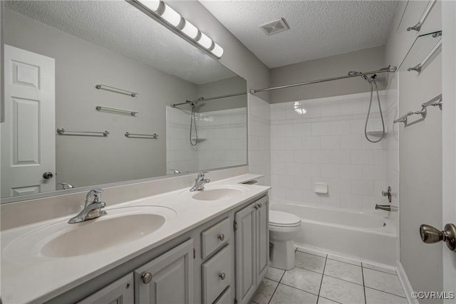 bathroom featuring a sink, tile patterned floors, a textured ceiling, and visible vents