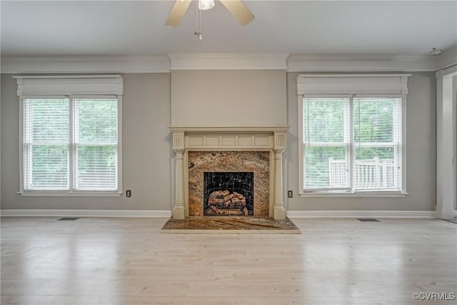 unfurnished living room featuring baseboards, a ceiling fan, wood finished floors, and visible vents